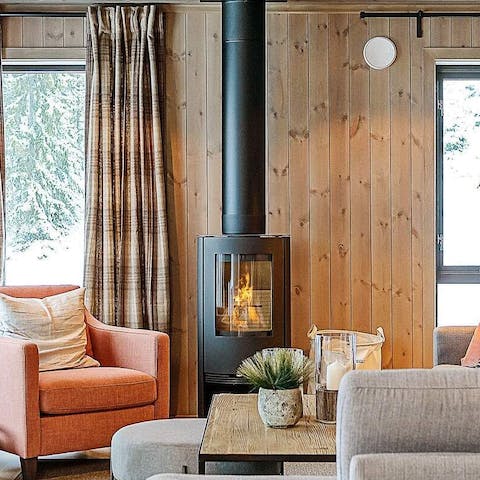 Cuddle up on the sofa beside the warm glow of the wood-burning stove