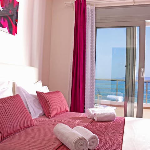 Open the doors to the private terrace from the bedroom to gaze at sea views