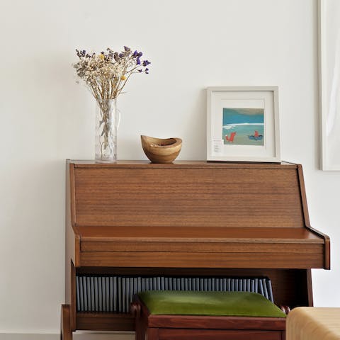 Play some tunes on the piano before sitting down to a meal in the sunny dining area