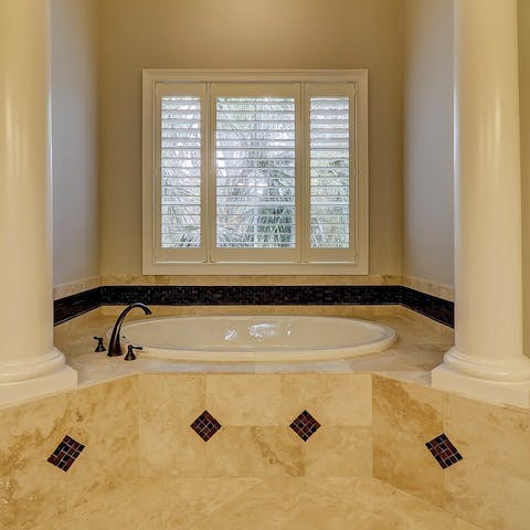 Soak in the extremely grand bathtub