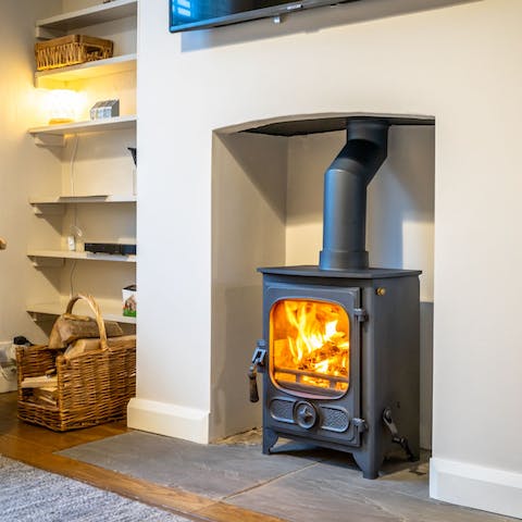 Cosy around the roaring wood burner on chilly evenings in