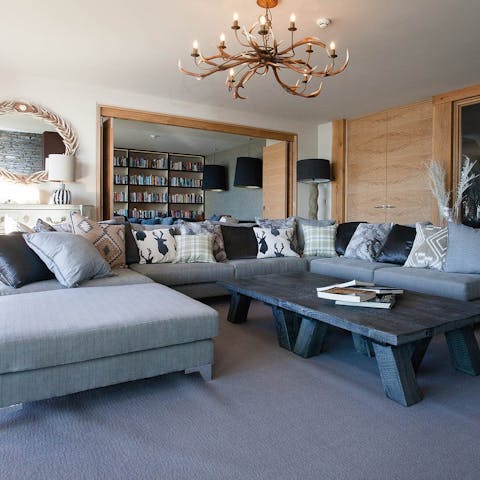 Relax on the designer furniture in the cinema room