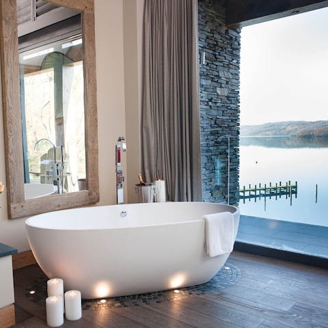 Watch the sunset over the water from the bathtub