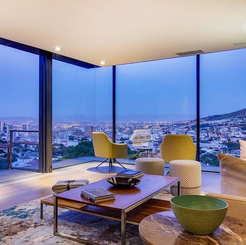 Watch the city sparkle from the perfectly poised living room