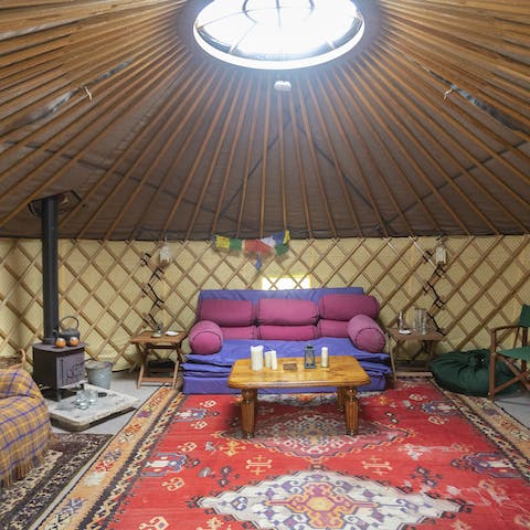 Cosy up by the wood-burner in the lakeside yurt 