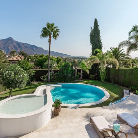 Lounge by the pool and admire the stunning mountain views