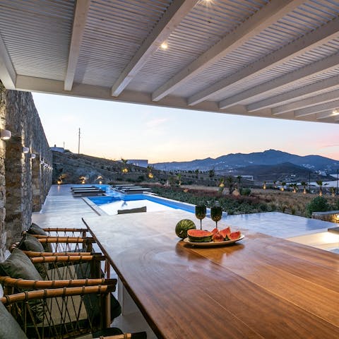 Dine alfresco as the sun sets over the distant mountains