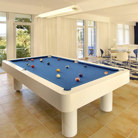 Challenge friends and family to a game of pool in between moments beneath the sun