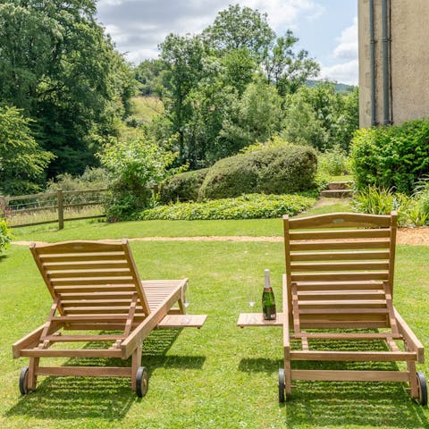 Pull up a lounger and relax on the grassy lawn as you admire the countryside views