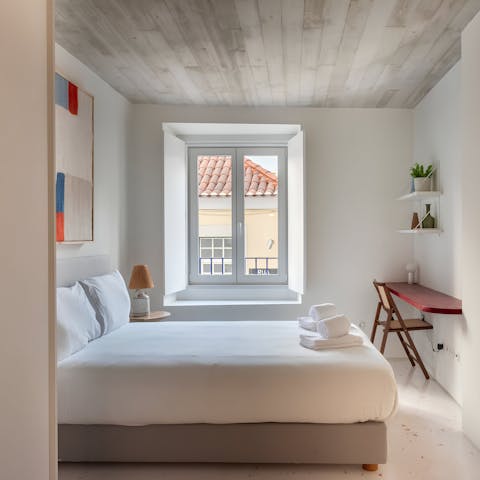Wake up to views of Alfama's terracotta rooftops from the serene bedroom