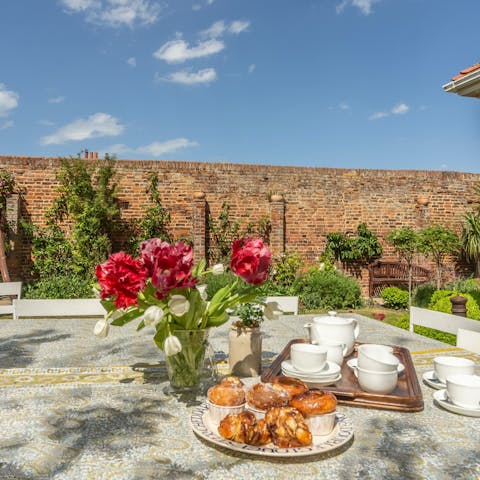 Enjoy some afternoon tea and cakes in the garden after a hike along the Norfolk Coast 