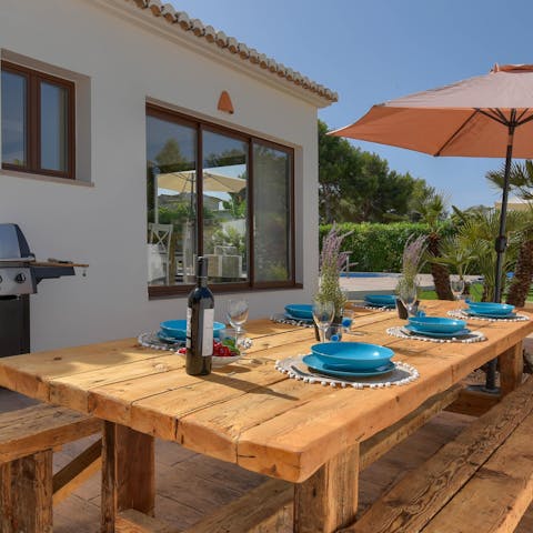 Share delicious meals and bottles of Spanish wine in the outdoor dining area 