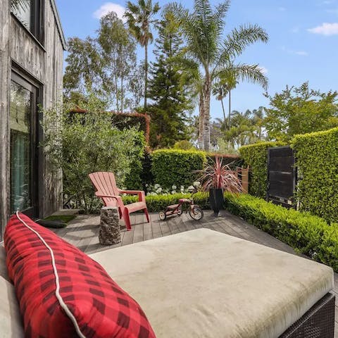 Relax in the private garden enclosed by verdant hedges