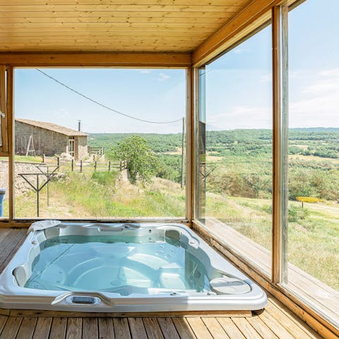Slip into the bubbling Jacuzzi and look out over the countryside