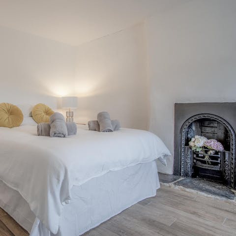 Drift off to sleep in the calm master bedroom, complete with its traditional fireplace