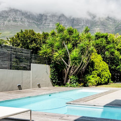 Admire the majestic mountain scenery from the private pool