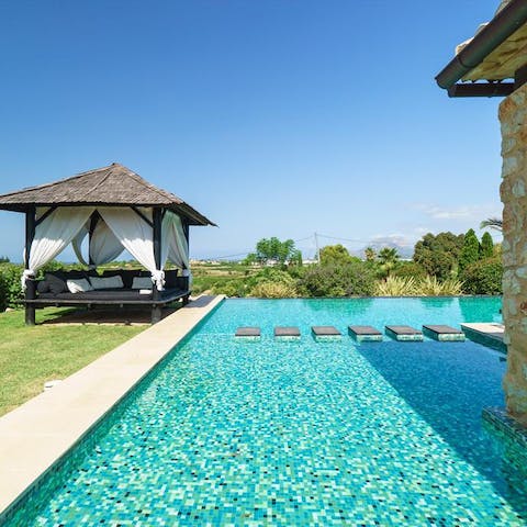 Pad across the pool's stepping stones to the double day bed