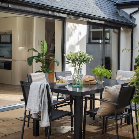 Open up the sliding doors, and blend the kitchen with the outdoor dining area 