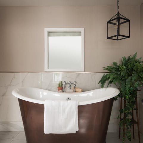 Sink back into the freestanding bath tub, after exploring the Welsh countryside 