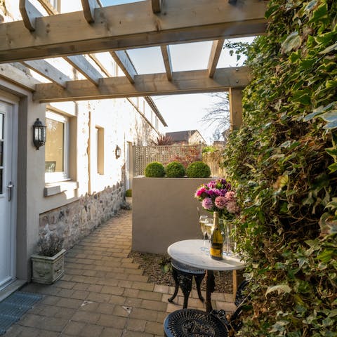 Sip wine under the pergola in your enclosed courtyard garden