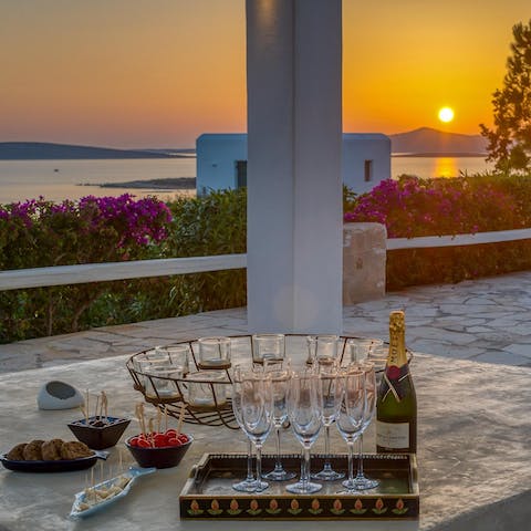 A glass of champagne in hand, watching the sunset — a perfect way to round off the evening