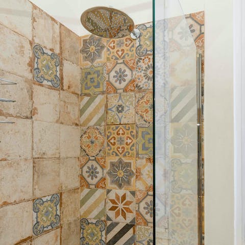 Admire the pretty mosaic tiles as you freshen up under the rainfall shower