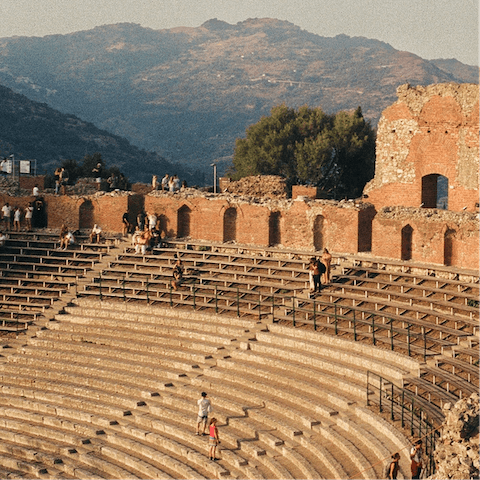 Admire ancient sights and beautiful scenery from Teatro Antico di Taormina