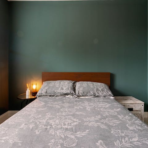 Wake up feeling refreshed after a day in the city, in the calming teal bedroom