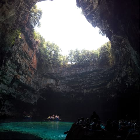 Take a boat trip to the crystal-clear waters of Melissani Cave, eight minutes away