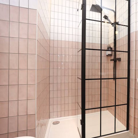 Freshen up in the pink tiled ensuite, under the rainfall shower