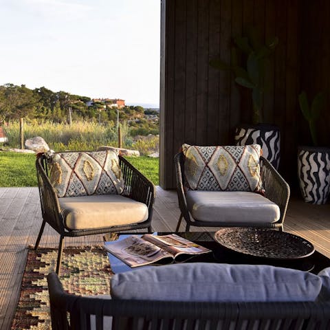 Enjoy the views at sunset from this cosy spot on the patio