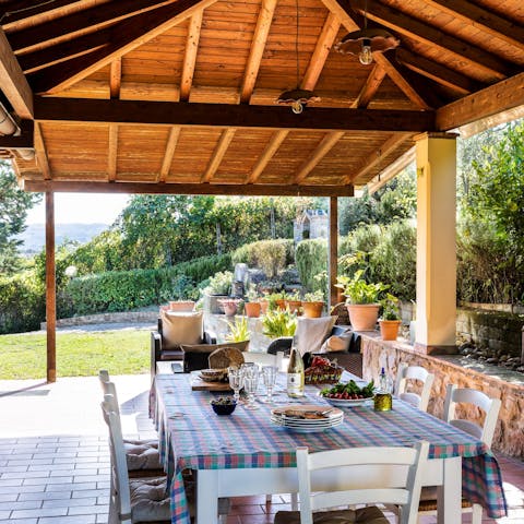 Dine alfresco under the pergola, surrounded by the stunning Tuscan countryside