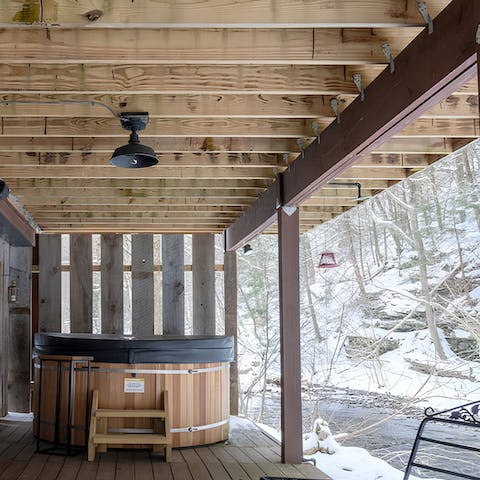 Sink into the hot tub for a soak overlooking the brook and forest