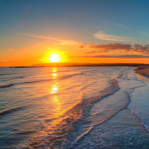 Watch breathtaking sunsets from Camber Sand Beach