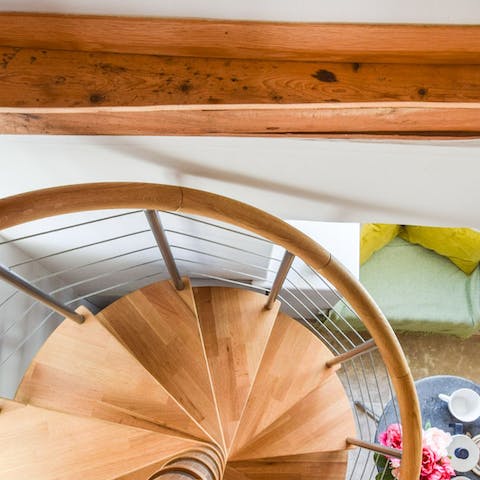 Climb the elegant spiral staircase up to the bedroom