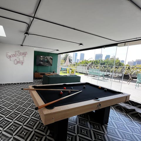 Compete in a game of pool with friends in the building's games room