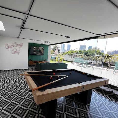 Compete in a game of pool with friends in the building's games room