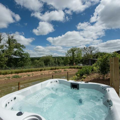 Relax in the private hot tub after an adventure on the lake