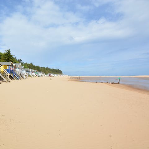 Spend warm afternoons sunbathing at the beach, just over a mile away