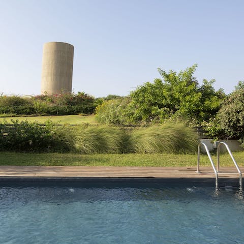Take a refreshing dip in the private pool surrounded by beautiful greenery