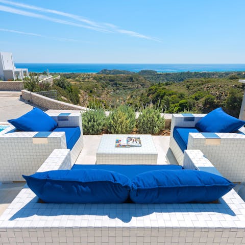 Nestle into one of the outdoor sofas and enjoy the sea view