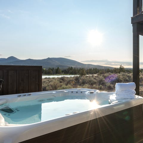 Soak in the private hot tub as the sun dips below the mountains