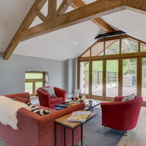 Unwind in this romantic living room, with wood beams and full-sized windows