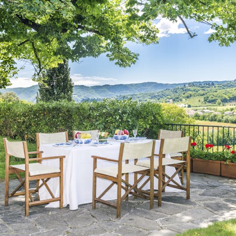 Dine alfresco in the shade of the trees with stunning views of the Vicenza countryside