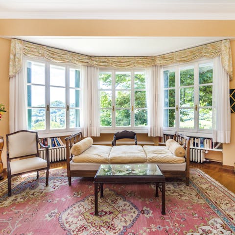 Relax in the living area of the ground floor master bedroom as sunlight floods through large windows