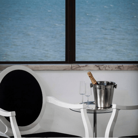 Pour yourself a glass of white wine and watch the boats go by on the contemporary chairs
