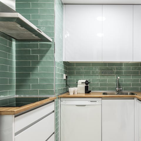 Cook up a tasty breakfast with fresh coffee in the pretty green tiled kitchen