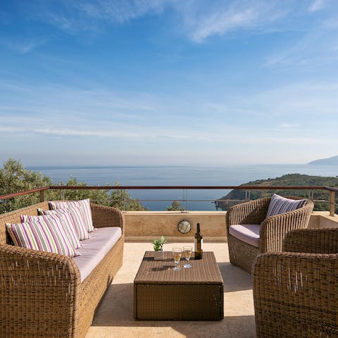 Watch the sunset with a glass of wine in hand on the rattan couches