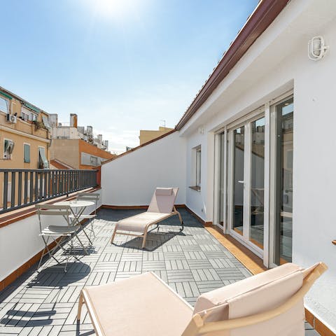 Soak up the Spanish sun from the private terrace as the city bustles below