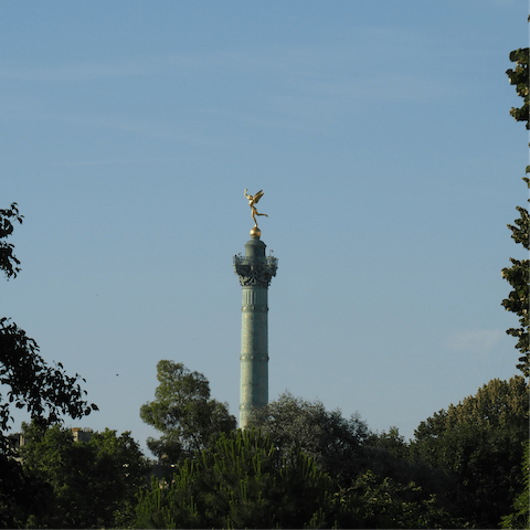 Visit the iconic Place de la Bastille and stand where the Bastille prison once stood